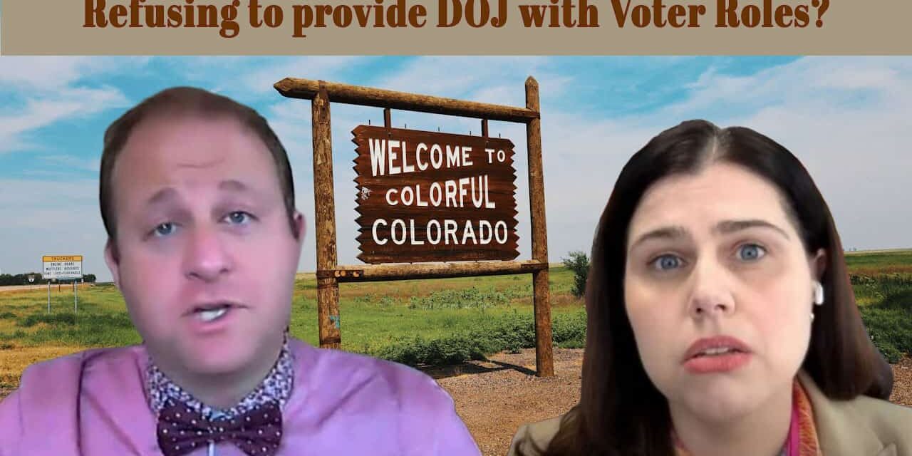 1. Protest against DOJ voter roles refusal in Colorado with two individuals expressing concern, symbolic welcoming sign in the background.