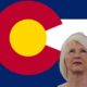 Colorado state flag with Tina Peters looking up, representing Colorado politics and culture.
