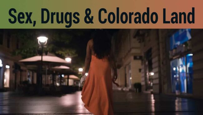 Woman walking alone at night in an urban area, illuminated by streetlights, representing themes of controversy surrounding sex work, drugs, and land disputes in Colorado.