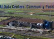 An aerial view of a large 5G AI data center surrounded by green fields and infrastructure, highlighting the role of technology hubs in community development and connectivity.