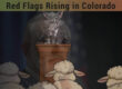 Illustration of a wolf-like figure at a podium with sheep in the foreground, symbolizing political warning signs in Colorado.